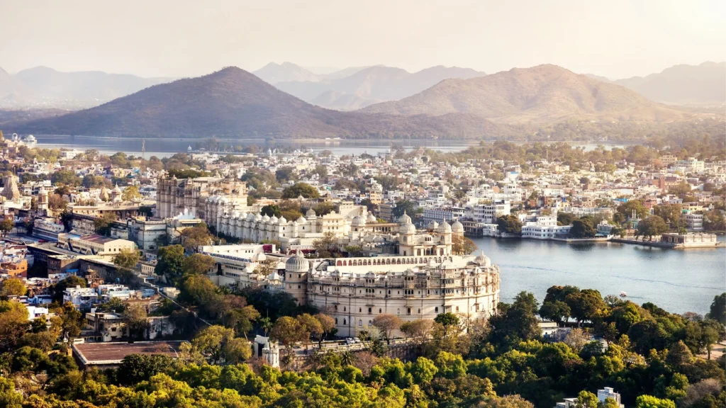 A panoramic view of Lake Pichola in Udaipur, with the City Palace and Lake Palace hotels in the background.