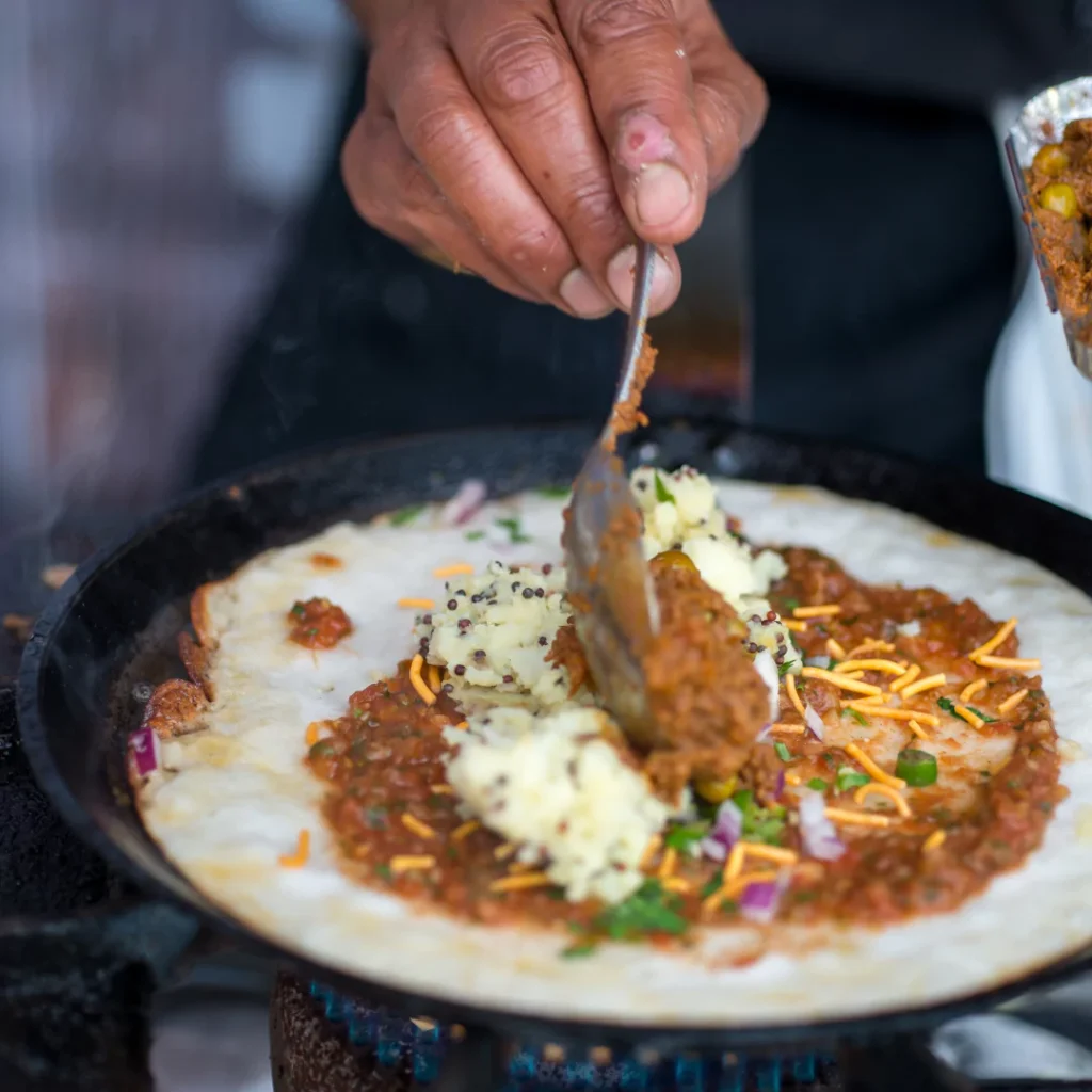 A fun interactive dosa station at an Indian wedding, with guests of all ages creating their own personalized dishes.