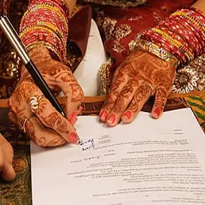 Couple signing marriage registration documents in India